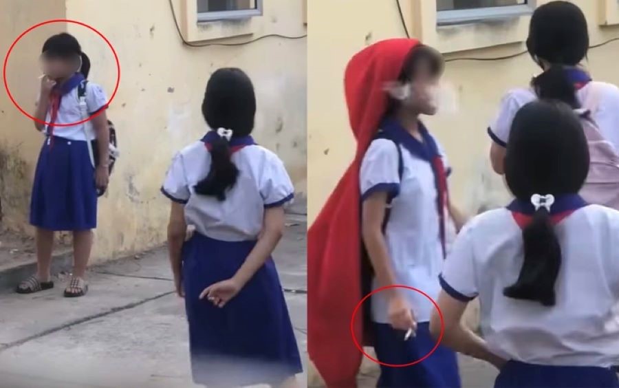 Nhóm nữ học sinh tiểu học hút thuốc trong sân trường ở An Giang. (Ảnh chụp màn hình)